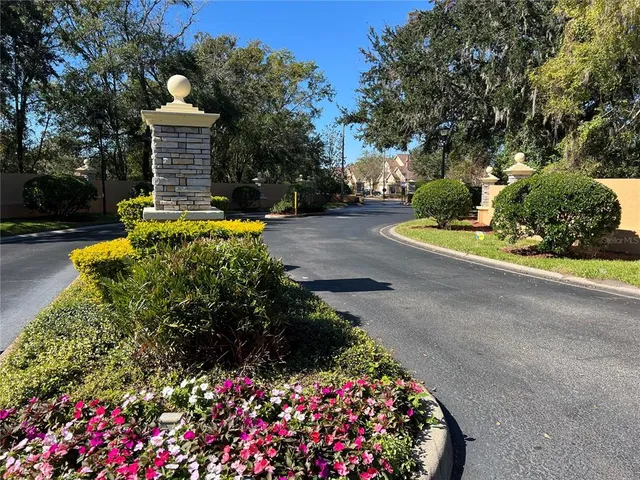 a front view of a house with a yard and fountain