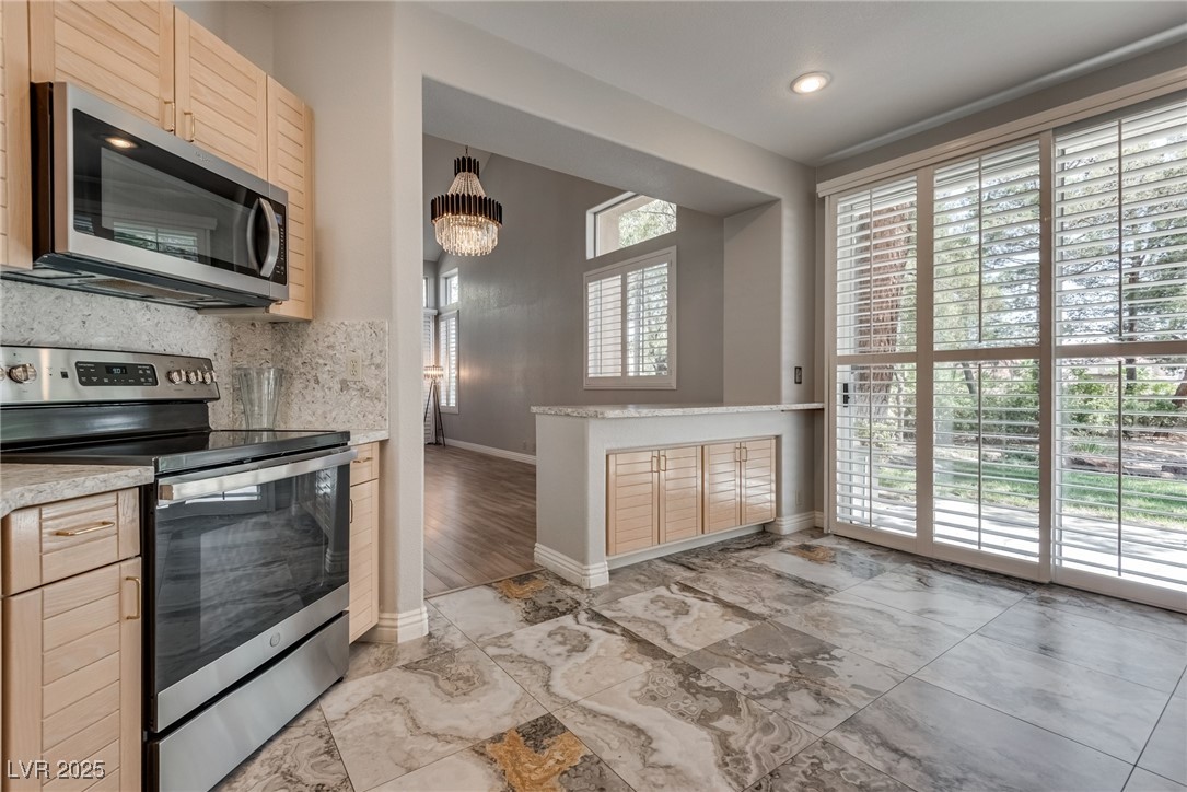 Kitchen featuring stainless steel appliances, ligh