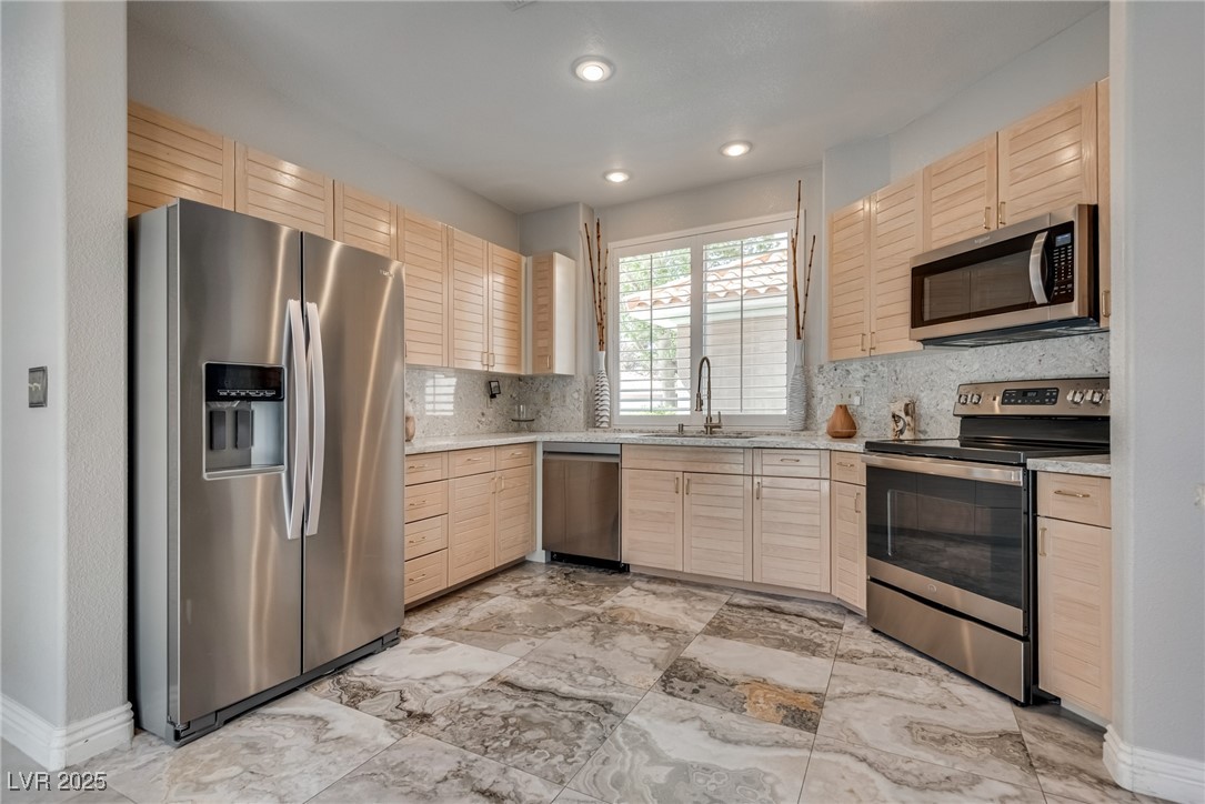 8541 Heather Downs Drive Las Vegas, NV 89113 - Photo 11 of 39 Kitchen with stainless steel appliances, light bro