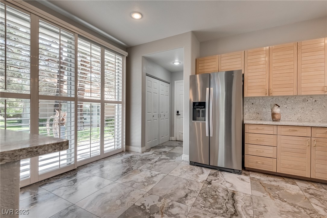 8541 Heather Downs Drive Las Vegas, NV 89113 - Photo 13 of 39 Kitchen featuring stainless steel fridge with ice