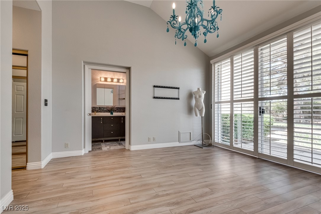 8541 Heather Downs Drive Las Vegas, NV 89113 - Photo 18 of 39 Unfurnished room featuring high vaulted ceiling, a
