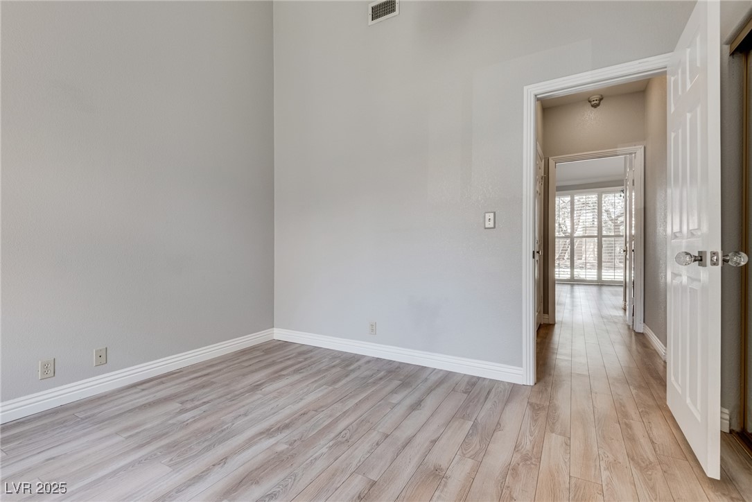 8541 Heather Downs Drive Las Vegas, NV 89113 - Photo 19 of 39 Spare room with light wood-type flooring and baseb