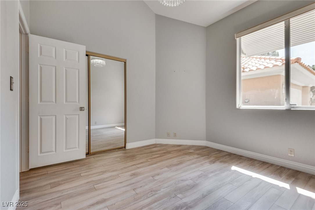 8541 Heather Downs Drive Las Vegas, NV 89113 - Photo 20 of 39 Empty room featuring light wood finished floors an