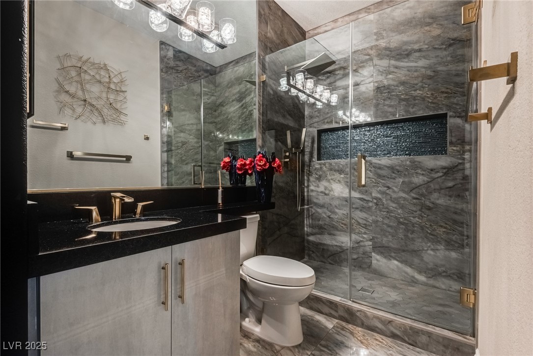 8541 Heather Downs Drive Las Vegas, NV 89113 - Photo 21 of 39 Bathroom featuring toilet, vanity, a marble finish