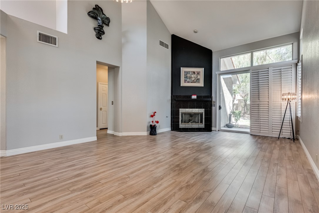 8541 Heather Downs Drive Las Vegas, NV 89113 - Photo 3 of 39 Unfurnished living room with high vaulted ceiling,