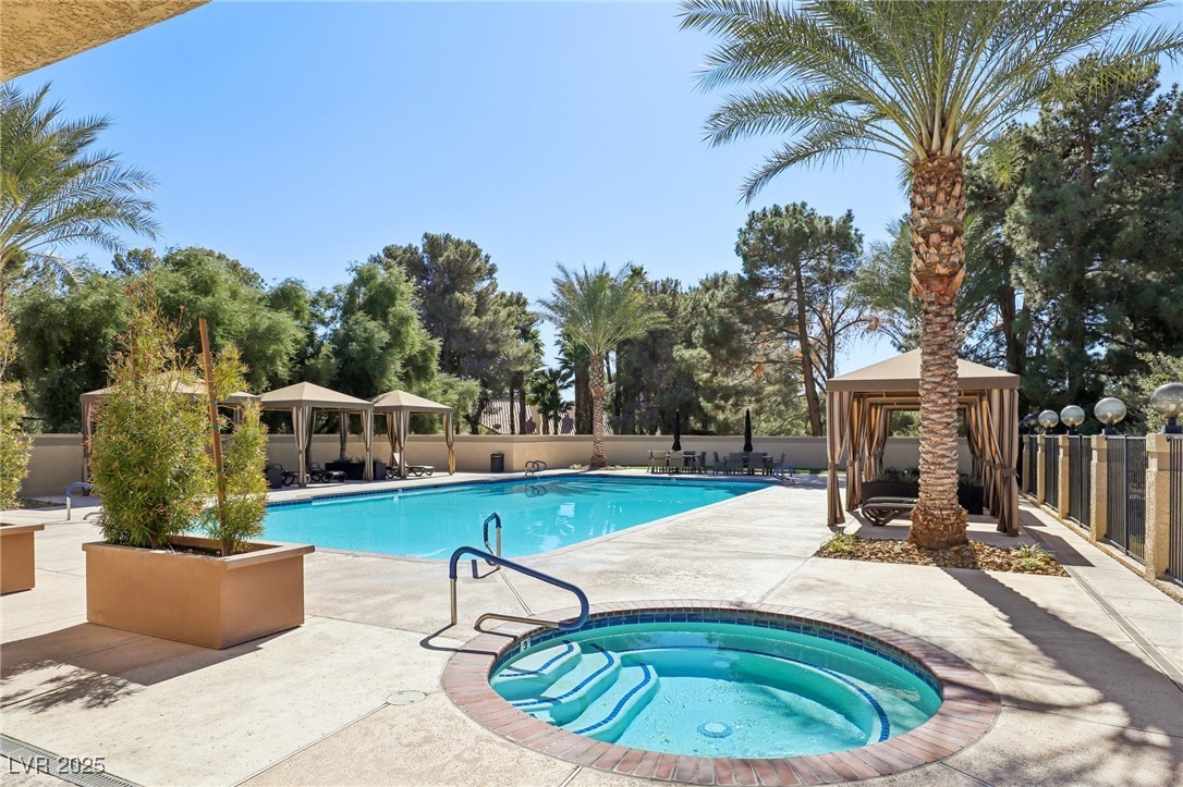 8541 Heather Downs Drive Las Vegas, NV 89113 - Photo 32 of 39 Community pool with a gazebo, a community hot tub,
