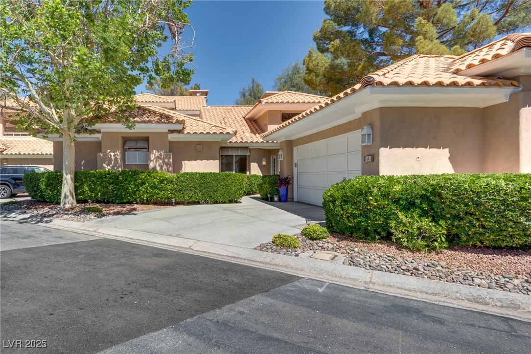 8541 Heather Downs Drive Las Vegas, NV 89113 - Photo 37 of 39 View of front of house with stucco siding, a garag