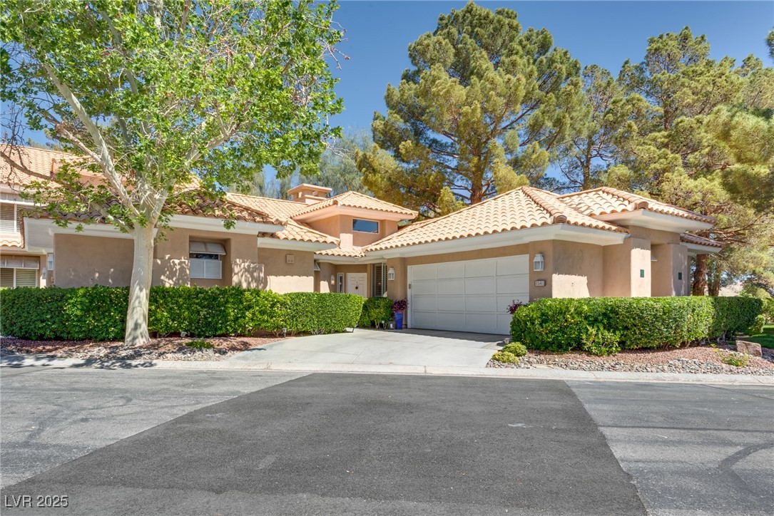 8541 Heather Downs Drive Las Vegas, NV 89113 - Photo 8 of 39 View of front facade with an attached garage, stuc