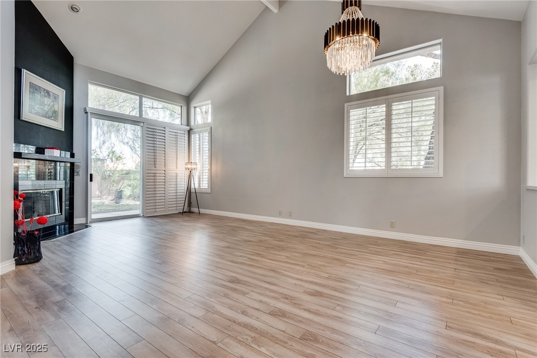8541 Heather Downs Drive Las Vegas, NV 89113 - Photo 9 of 39 Unfurnished living room with a chandelier, light w