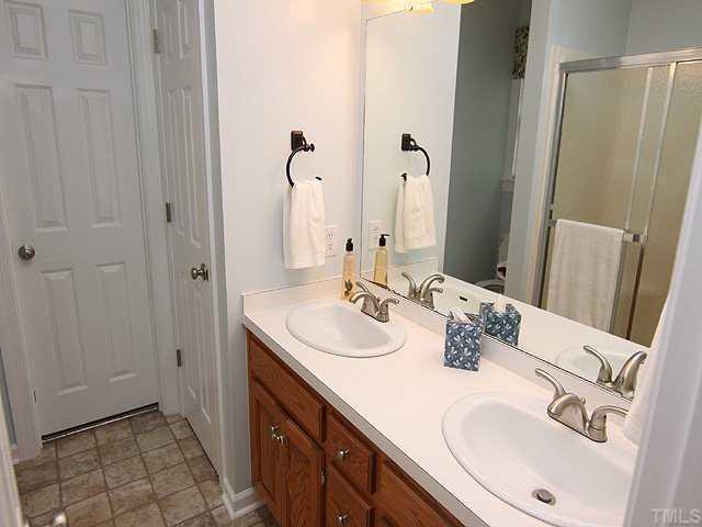 1109 Riderwood Court Willow Spring, NC 27592 - Photo 7 of 11 Dual sinks and new fixtures plus fresh paint in this master bath...Note the extra large shower with seat and walk in closet access!
