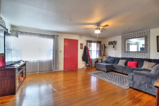 a kitchen with stainless steel appliances a refrigerator a stove and white cabinets