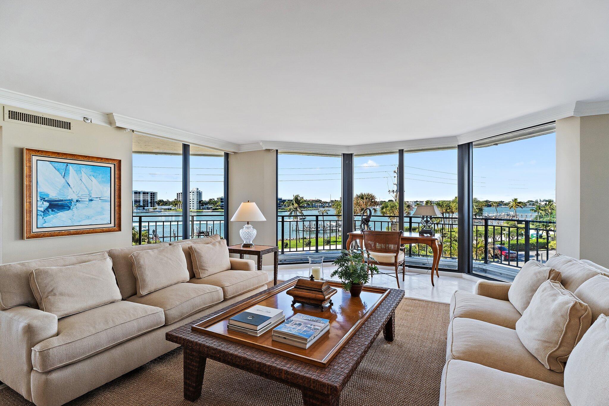 19850 South Beach Road, Unit 3D Jupiter, FL 33469 - Photo 1 of 54 a living room with furniture and a large window