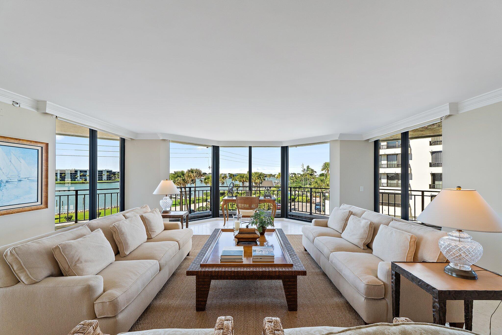 19850 South Beach Road, Unit 3D Jupiter, FL 33469 - Photo 13 of 54 a living room with furniture and a large window with balcony view