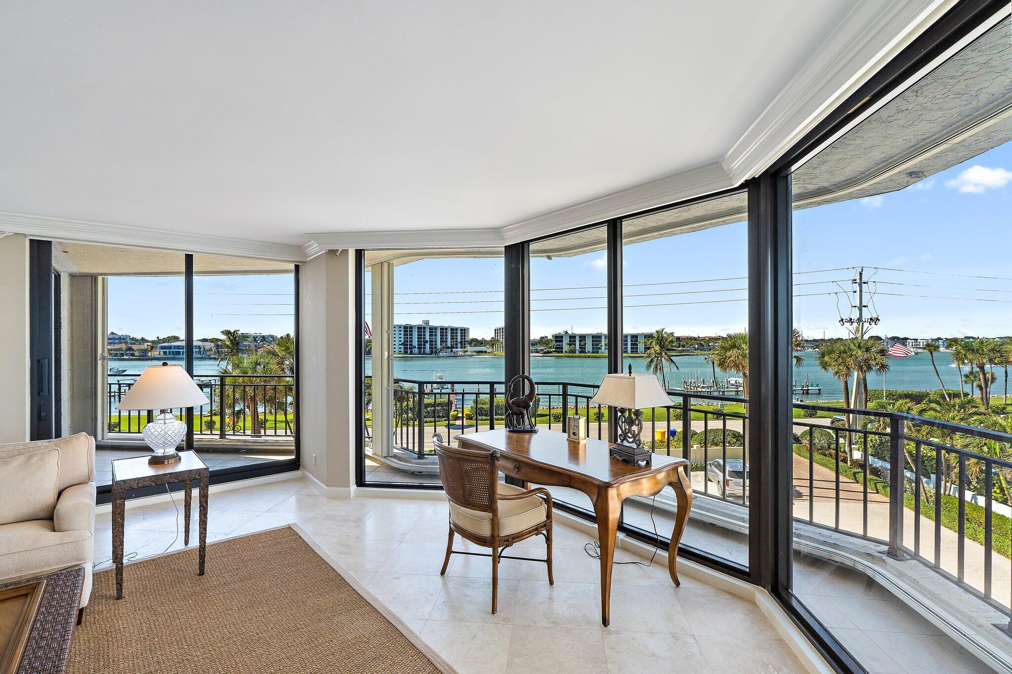 19850 South Beach Road, Unit 3D Jupiter, FL 33469 - Photo 14 of 54 a living room with furniture and floor to ceiling windows