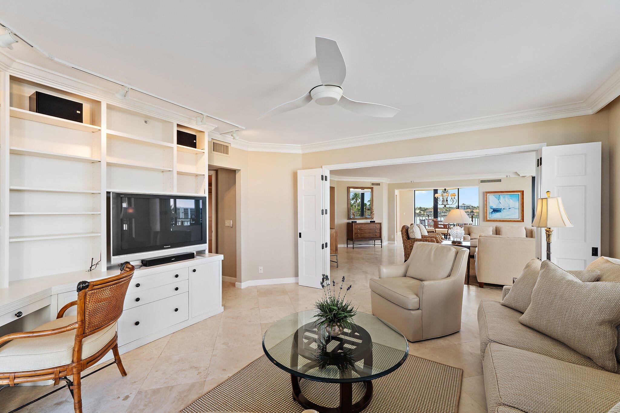 19850 South Beach Road, Unit 3D Jupiter, FL 33469 - Photo 16 of 54 a living room with furniture a flat screen tv and kitchen view