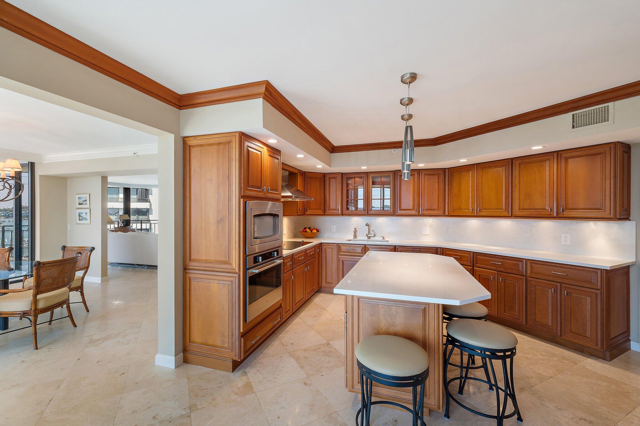 19850 South Beach Road, Unit 3D Jupiter, FL 33469 - Photo 21 of 54 a kitchen with stainless steel appliances granite countertop a sink and a refrigerator
