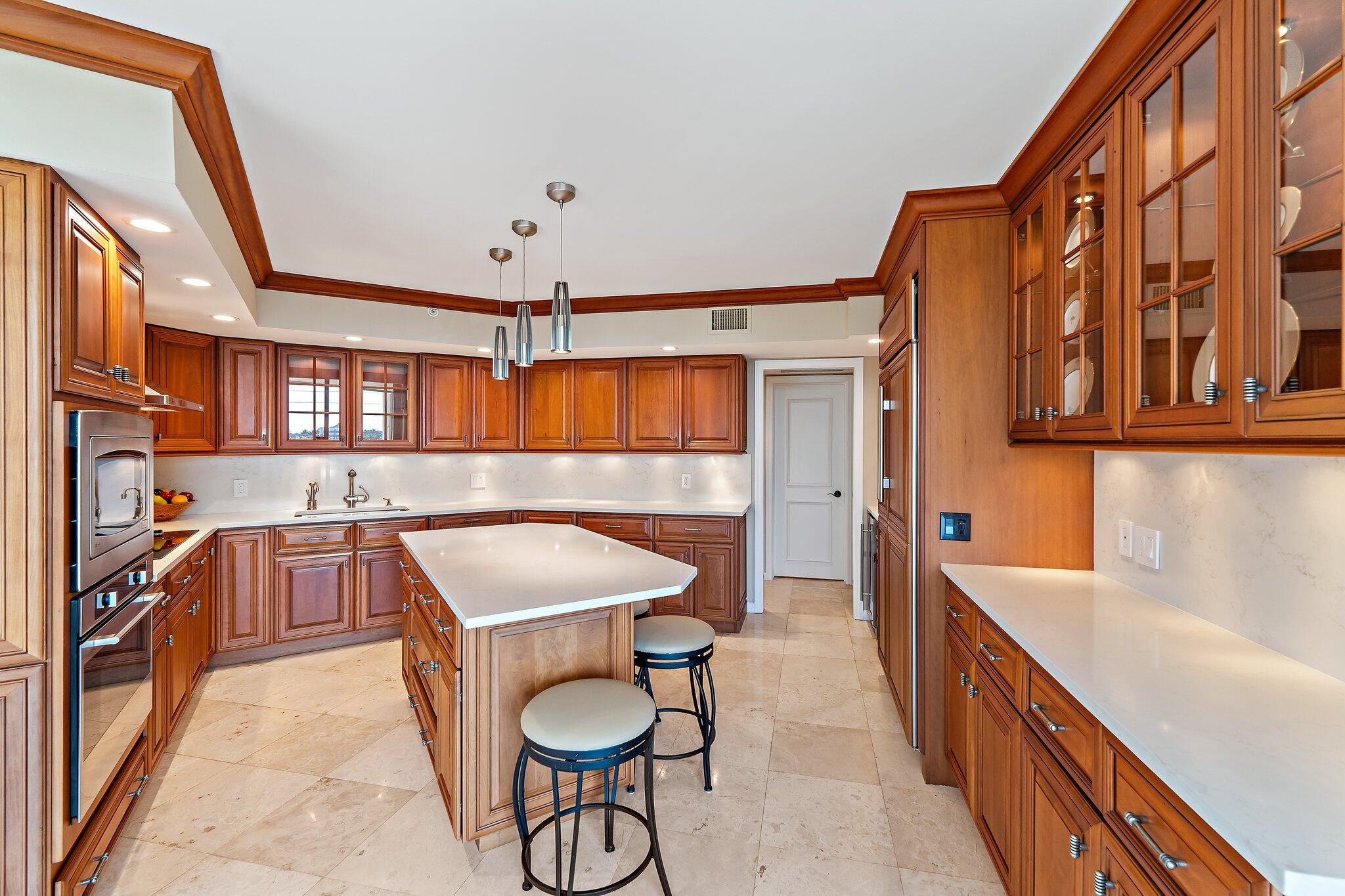 19850 South Beach Road, Unit 3D Jupiter, FL 33469 - Photo 26 of 54 a kitchen that has a lot of cabinets in it
