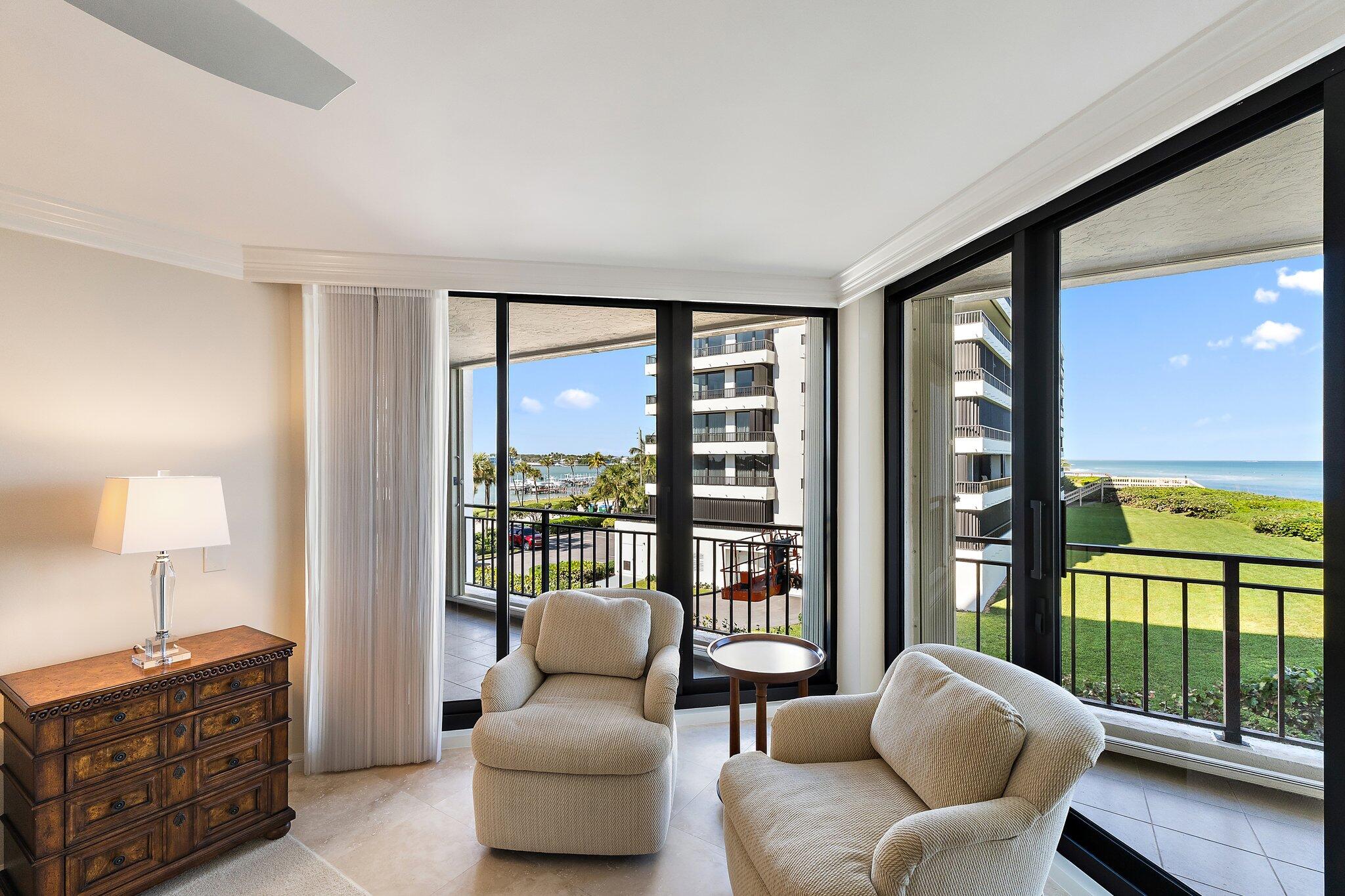 19850 South Beach Road, Unit 3D Jupiter, FL 33469 - Photo 31 of 54 a living room with furniture and a floor to ceiling window