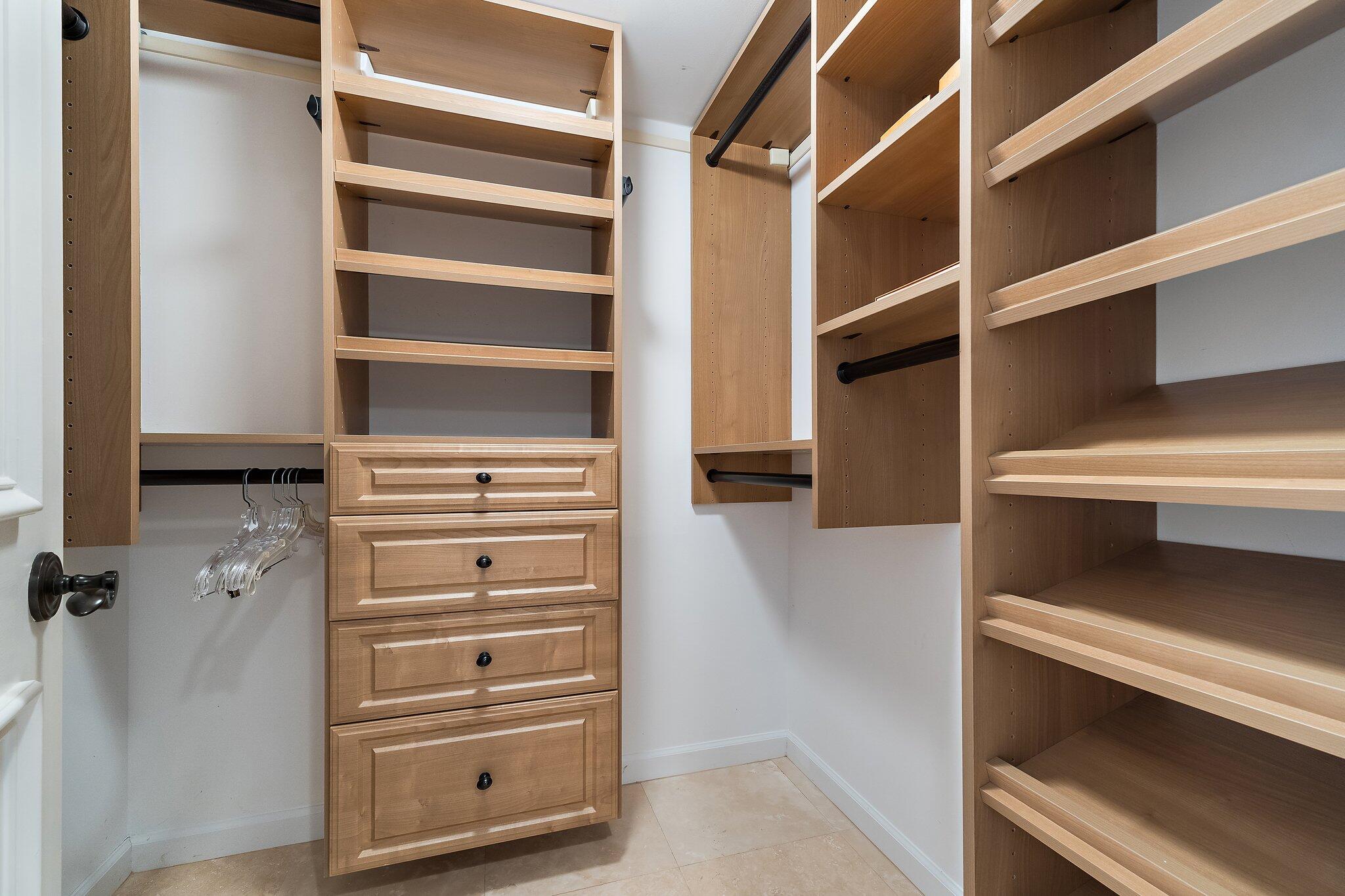 19850 South Beach Road, Unit 3D Jupiter, FL 33469 - Photo 38 of 54 a view of walk in closet with clothes and shoes