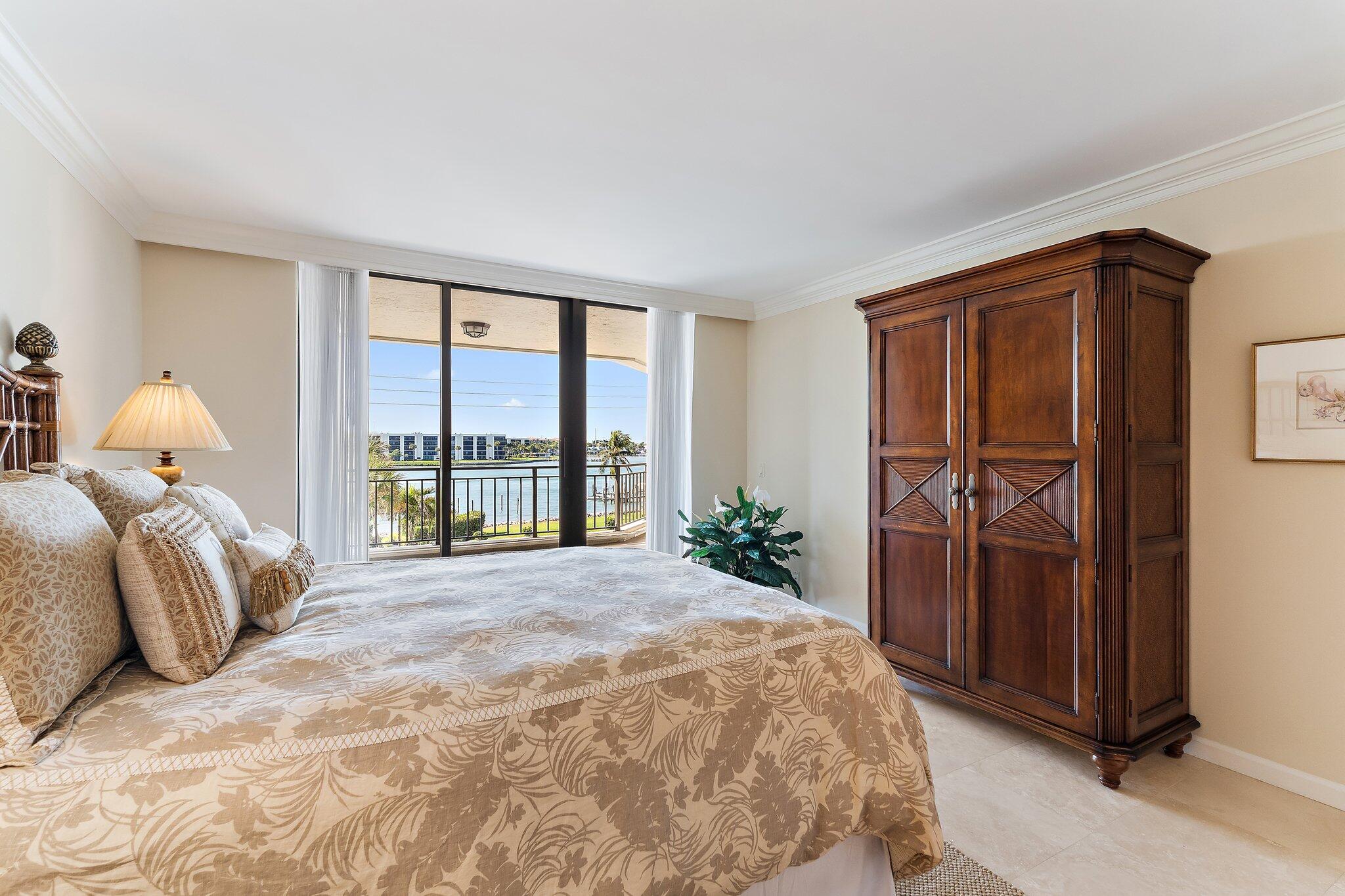 19850 South Beach Road, Unit 3D Jupiter, FL 33469 - Photo 40 of 54 a bedroom with a bed and a large window