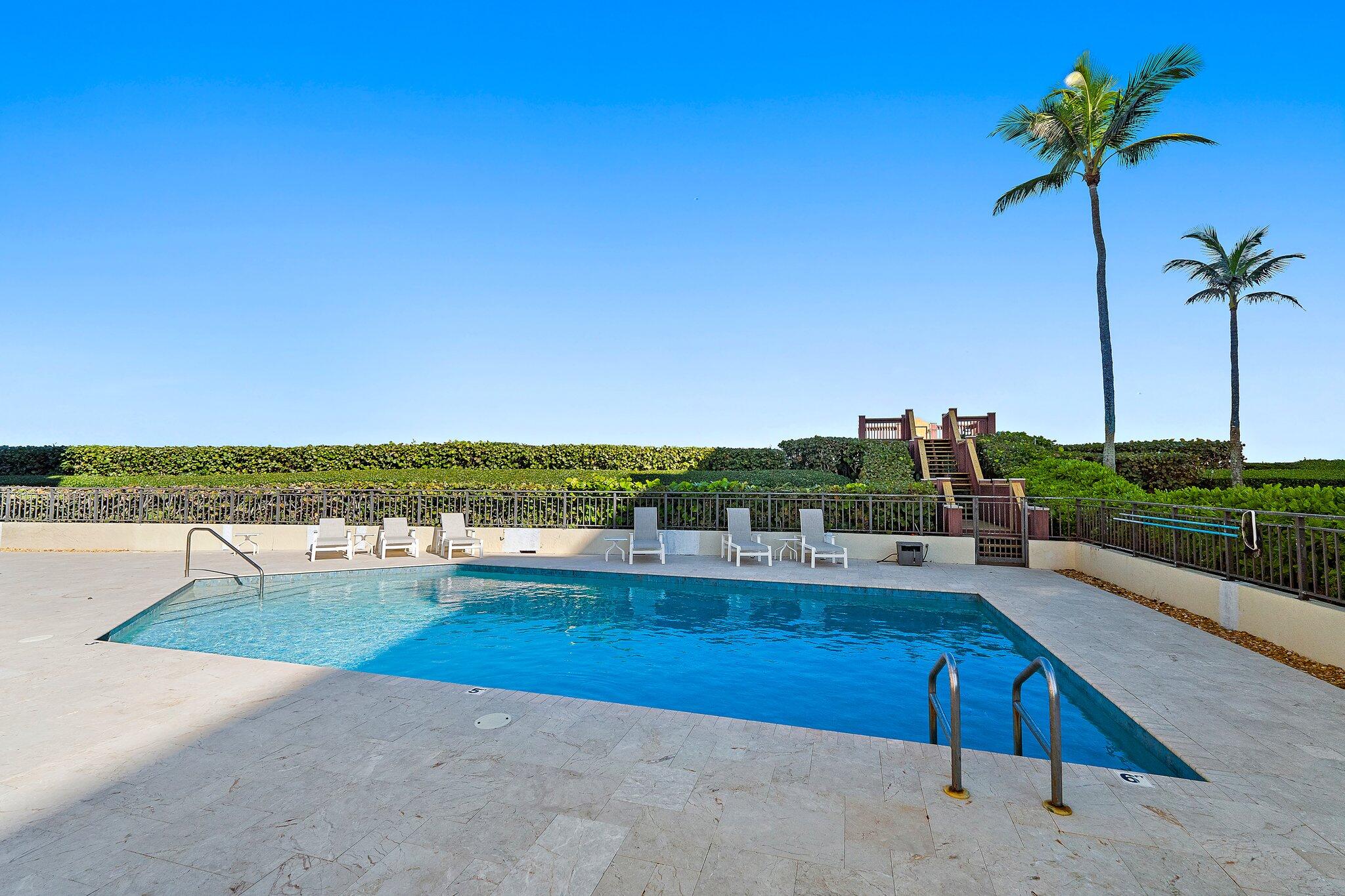 19850 South Beach Road, Unit 3D Jupiter, FL 33469 - Photo 46 of 54 a view of a swimming pool with a terrace