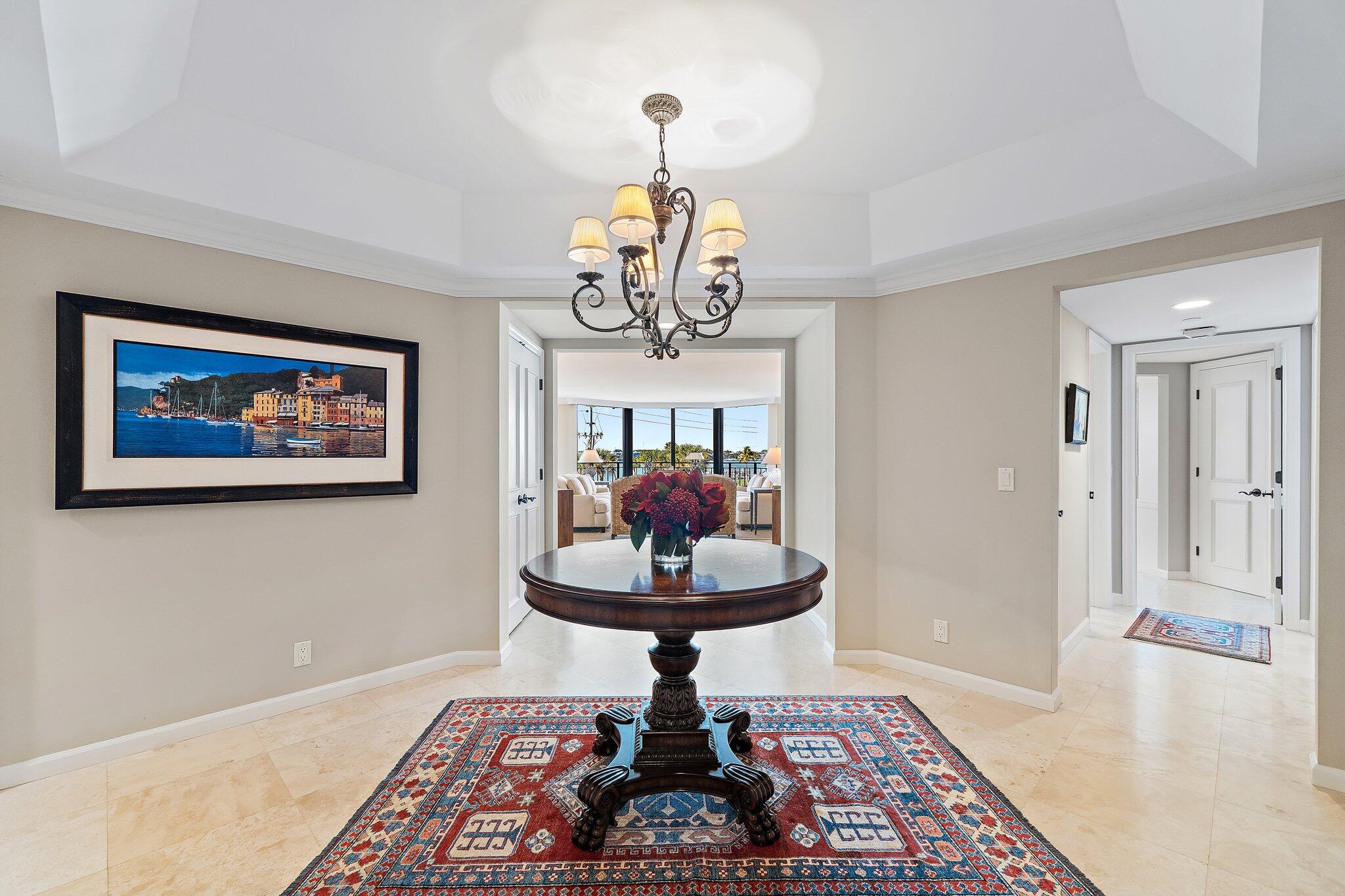 19850 South Beach Road, Unit 3D Jupiter, FL 33469 - Photo 9 of 54 a view of a livingroom with a chandelier and glass door