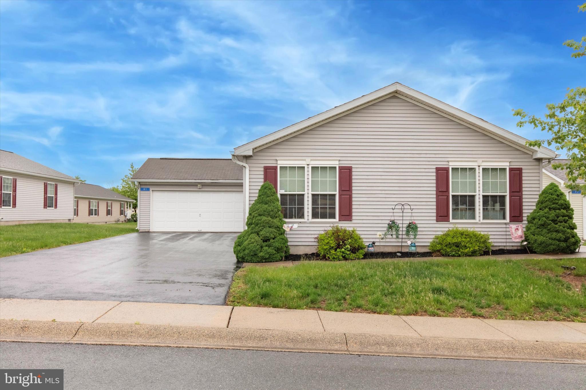 81 Random Road Douglassville, PA 19518 - Photo 3 of 31 a front view of a house with a yard and garage