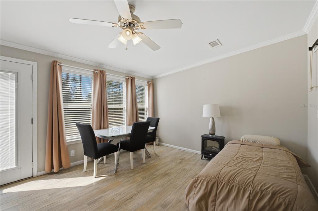 6844 Chad Jason Road St. Cloud, FL 34773 - Photo 27 of 59 a view of a bedroom with furniture window and wooden floor