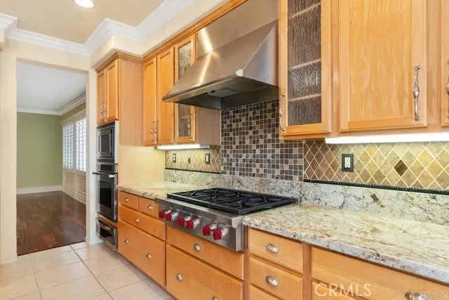 a kitchen with granite countertop a stove and a sink
