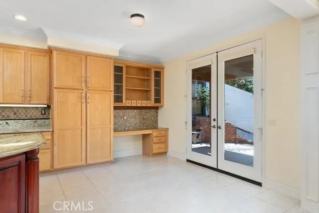 a view of an empty room with a fireplace and a window