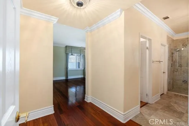 a view of a hallway with wooden floor