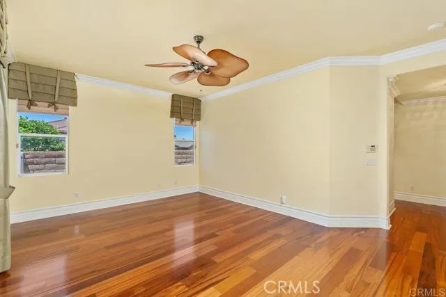 a view of a room with wooden floor and fan