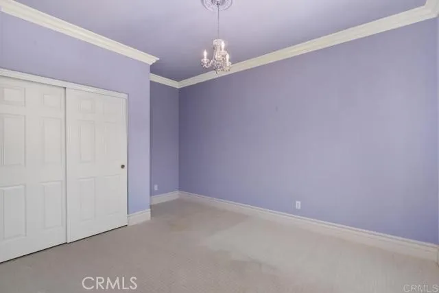 a view of a room with a window and a ceiling fan