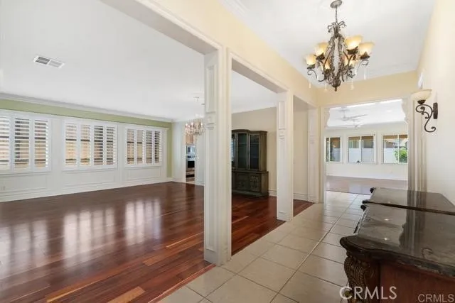 a view of a livingroom with wooden floor and a chandelier