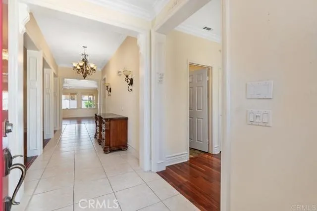 a view of a hallway view with wooden floor and a living room