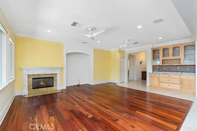 a open kitchen with a refrigerator and a stove top oven