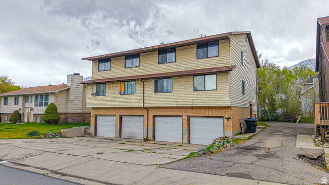 630 1100 West Provo, UT 84601 - Photo 2 of 64 Multi-level structure featuring light-colored siding, a brown roof, and multiple windows