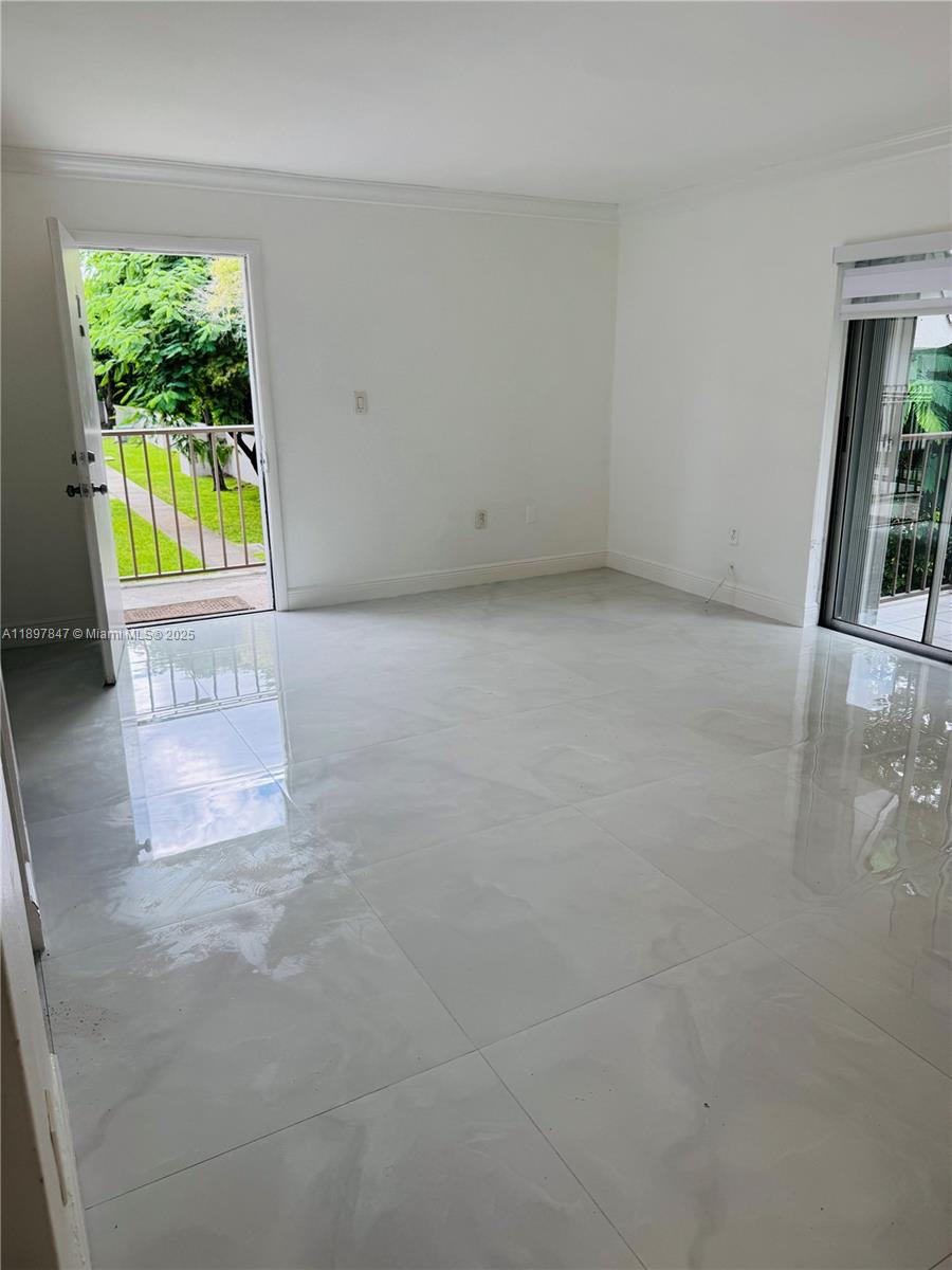 6961 Southwest 129th Avenue, Unit 7 Miami, FL 33183 - Photo 13 of 42 wooden floor in an empty room with a window