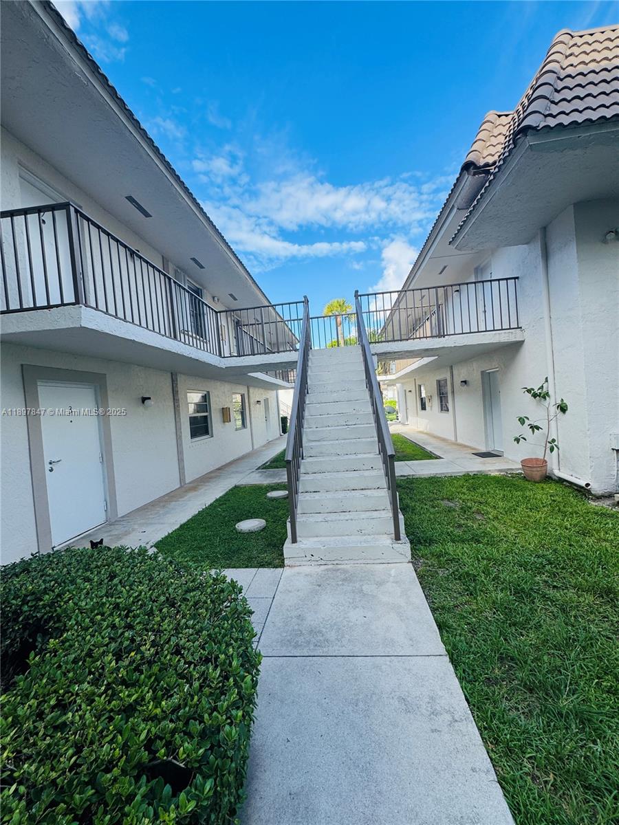 6961 Southwest 129th Avenue, Unit 7 Miami, FL 33183 - Photo 2 of 42 a view of a house with a yard