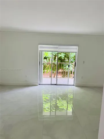 an empty room with large windows