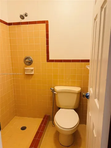 a bathroom with a toilet and a shower