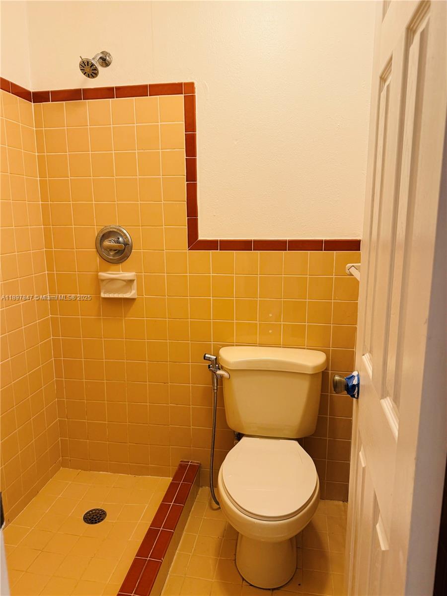 6961 Southwest 129th Avenue, Unit 7 Miami, FL 33183 - Photo 27 of 42 a bathroom with a toilet and a shower