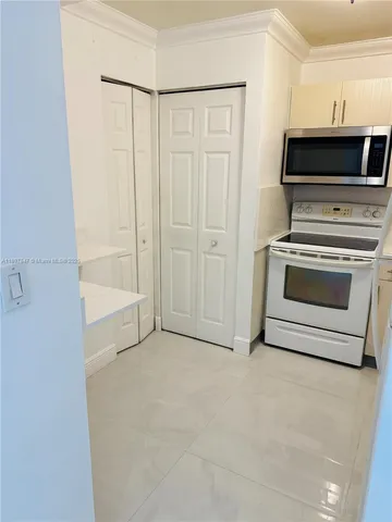 an empty room with closet and mirrors