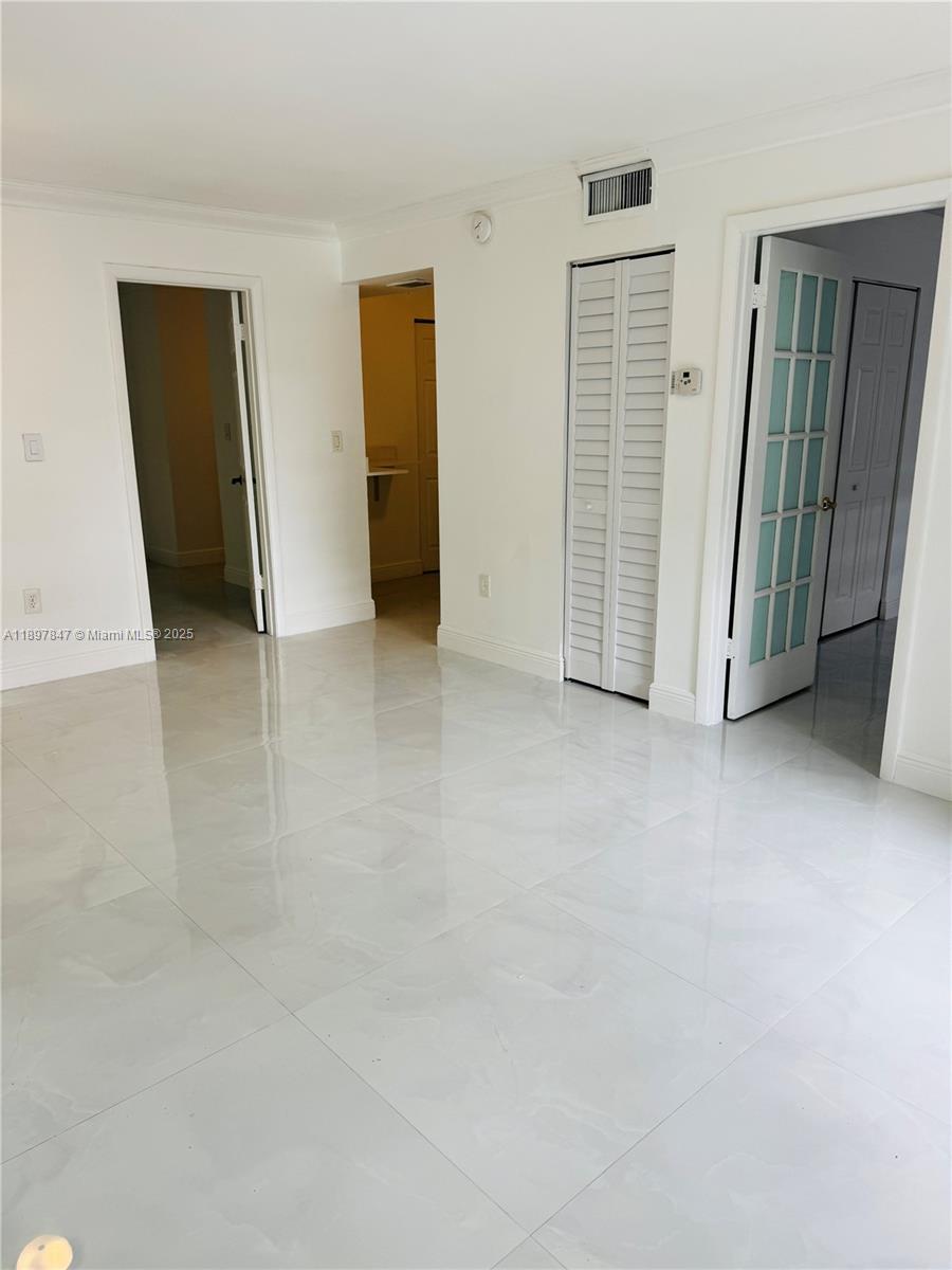 6961 Southwest 129th Avenue, Unit 7 Miami, FL 33183 - Photo 38 of 42 an empty room with closet and mirrors