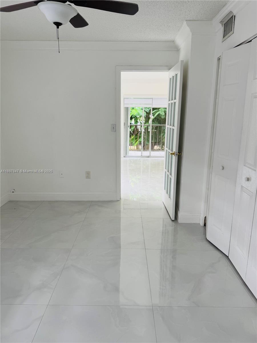 6961 Southwest 129th Avenue, Unit 7 Miami, FL 33183 - Photo 40 of 42 a view of an empty room with a window