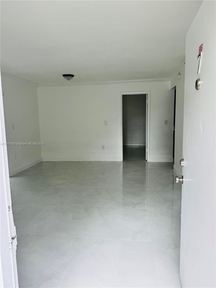 6961 Southwest 129th Avenue, Unit 7 Miami, FL 33183 - Photo 41 of 42 wooden floor and cabinet in an empty room