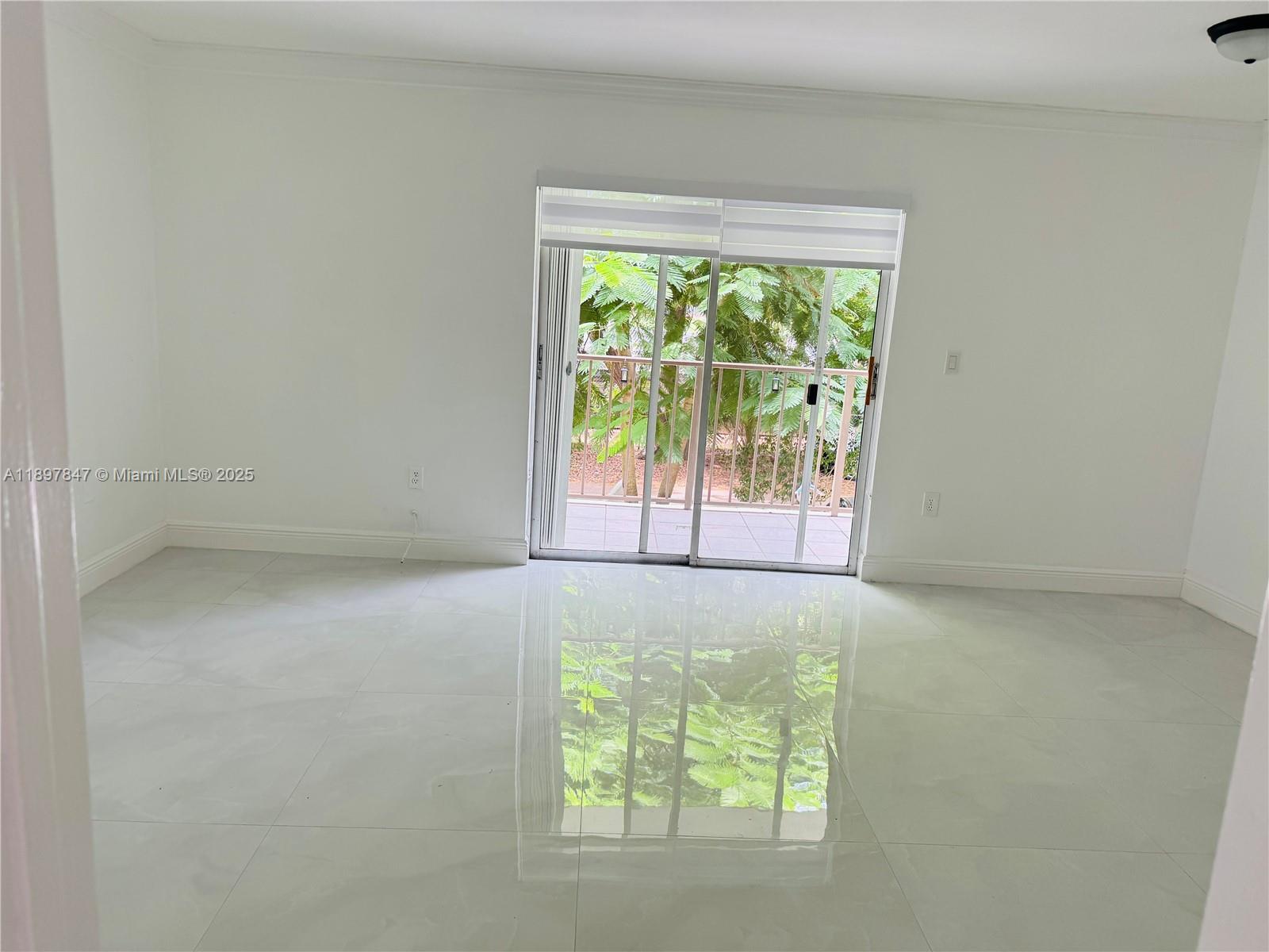 6961 Southwest 129th Avenue, Unit 7 Miami, FL 33183 - Photo 7 of 42 an empty room with windows