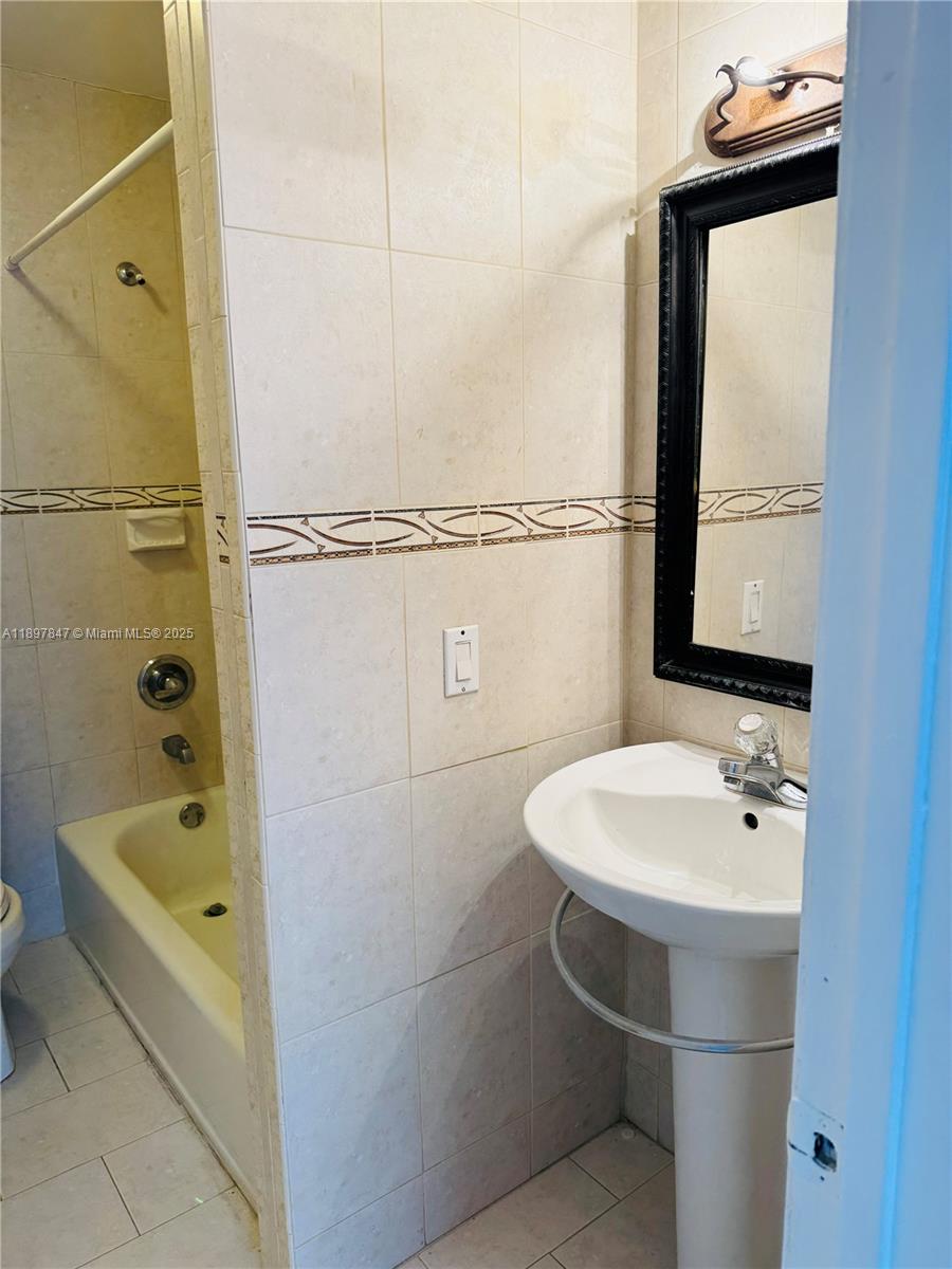 6961 Southwest 129th Avenue, Unit 7 Miami, FL 33183 - Photo 9 of 42 a bathroom with a sink a bath tub and a sink