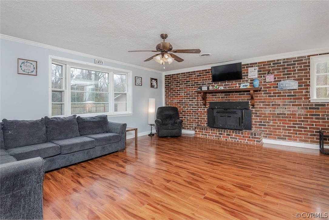 9420 Townsend Road Providence Forge, VA 23140 - Photo 13 of 29 a living room with furniture a fireplace and a flat screen tv