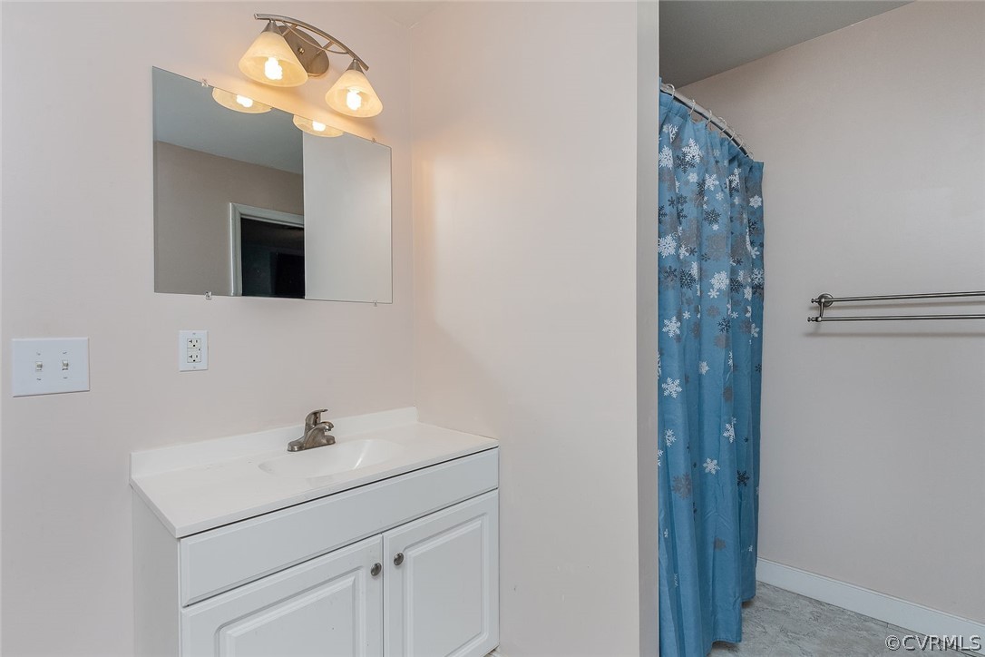 9420 Townsend Road Providence Forge, VA 23140 - Photo 18 of 29 a bathroom with a sink a light fixture and a light fixture